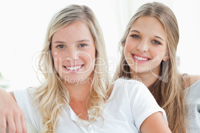 A pair of girls smiling as they look at the camera