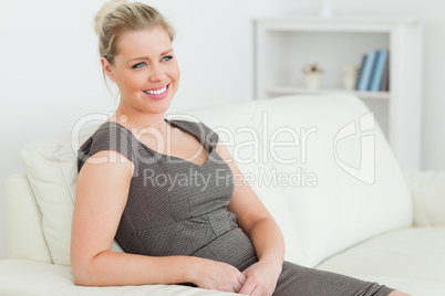 Pretty woman sitting on a sofa