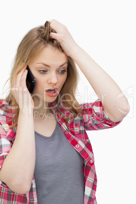 Annoyed woman holding a mobile phone