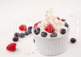 White jar of berries and whipped cream