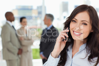 Young smiling businesswoman on the phone and tilting her head to
