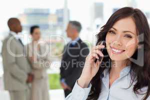Young smiling businesswoman on the phone and tilting her head to