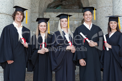 Smiling graduates posing