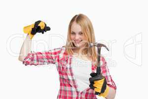 Joyful woman holding a hammer