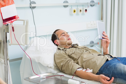 Transfused patient looking at a tablet computer