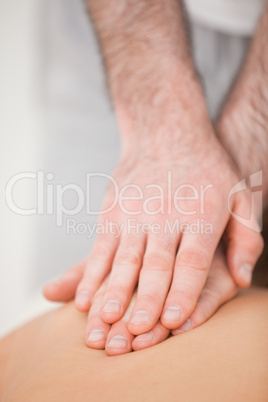 Osteopath massaging his patient while pressing his back