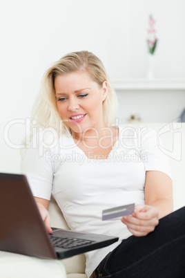 Casual woman using a laptop for shopping