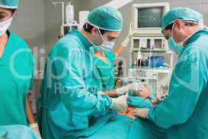 Surgeons operating with surgical tools