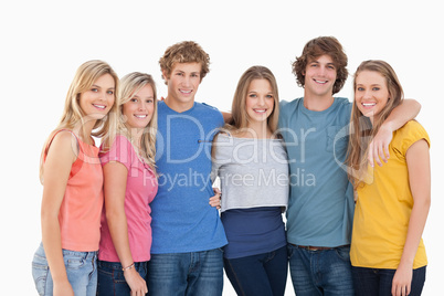 A group of friends smiling and holding each other