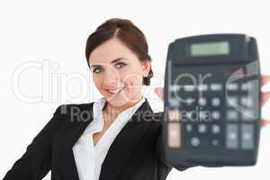 Smiling woman in black suit showing a calculator