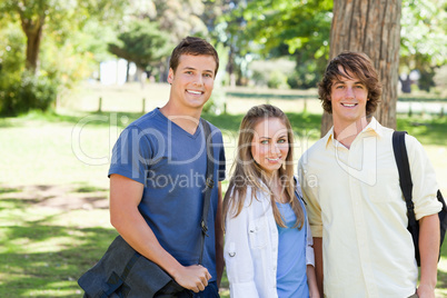 Portrait of smiling students with their bags