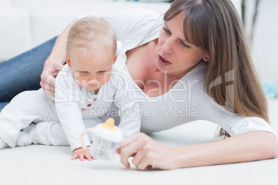 Baby and mother sitting on the floor