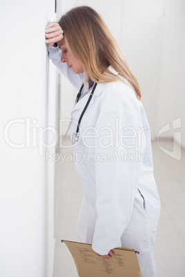 Doctor leaning on the wall