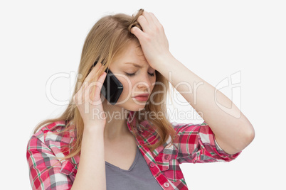 Upset woman holding a mobile phone