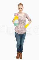 Woman standing while holding a spray bottle