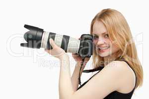 Woman looking at the camera while holding a camera