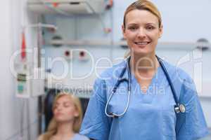 Nurse standing while looking at camera