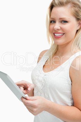Cheerful blonde woman touching her tablet computer Cheerful blonde woman touching her tablet computer