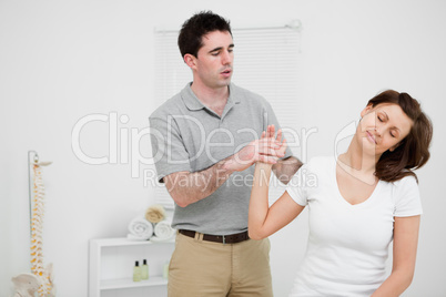 Peaceful woman being manipulated by a doctor