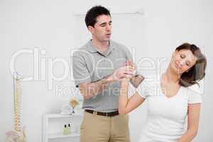 Peaceful woman being manipulated by a doctor