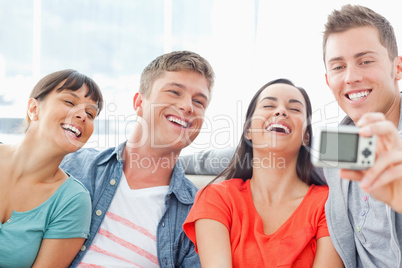 A laughing group pose for a funny photo