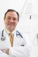 Smiling doctor folding his arms