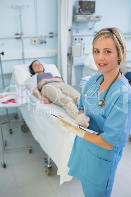 Nurse standing next to a transfused patient