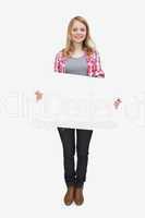 Woman holding a blank board while standing