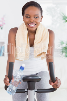 Black woman sitting on an exercise bike