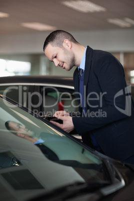 Salesman looking inside the car