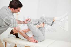 Woman holding her leg while being manipulated