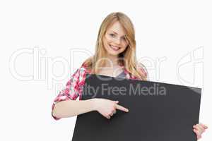 Woman showing a black board with her finger