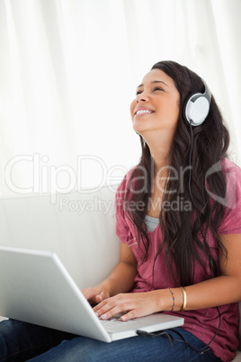 Close-up of a laughing Latino student using a laptop