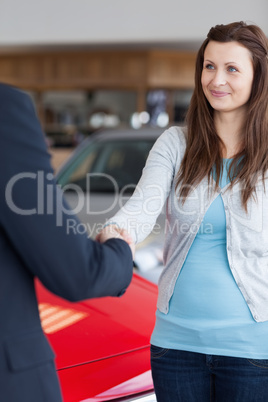 Woman shaking hand to a dealer