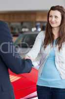 Woman shaking hand to a dealer