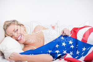 Laughing blonde woman with a US flag