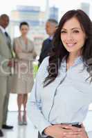 Young businesswoman standing upright with her hands crossed on h