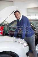 Man leaning above a car