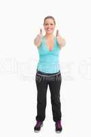 Woman wearing sportswear with thumbs up