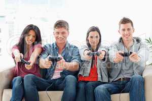 A group with arms out smiling as they play games together