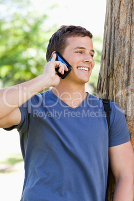 Close-up of a smiling young man on the phone