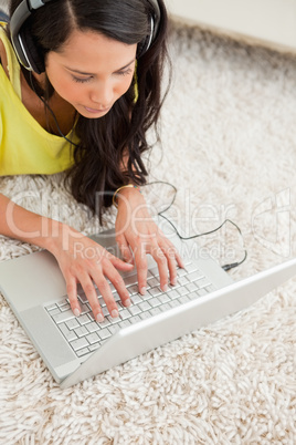 High-angle view of a smiling Latin chatting on a laptop