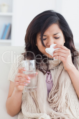 Sick woman blowing her nose