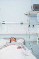 Female patient sleeping on a medical bed
