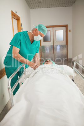 Patient lying on a medical bed next to a surgeon