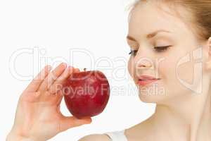 Woman holding an apple while looking at it