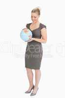 Woman looking at a globe