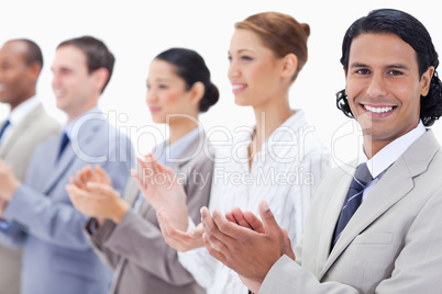 Close-up of a business team smiling and applauding
