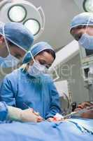 Doctors operating with surgical tools