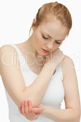 Woman touching her painful elbow